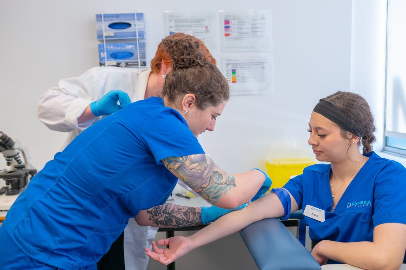 Healthcare students practicing in a training lab.